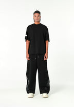 Pantalón barrel con cintas asimétricas MWM y bajos ajustables | MWM [PS_COLORS:BLACK]