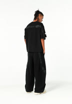 Pantalón barrel con cintas asimétricas MWM y bajos ajustables | MWM [PS_COLORS:BLACK]