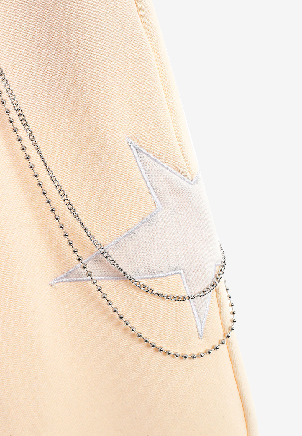 Pantalón jogger Wings con parches de estrellas y cadena lateral | MWM [PS_COLORS:BEIGE]