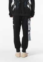 Pantalón jogger Wings con parches de estrellas y cadena lateral | MWM [PS_COLORS:BLACK]