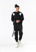 Pantalón jogger Wings con parches de estrellas y cadena lateral | MWM [PS_COLORS:BLACK]