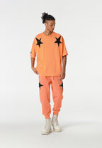 Pantalón jogger Wings con parches de estrellas y cadena lateral | MWM [PS_COLORS:ORANGE]