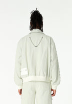 Chaqueta bomber vaquera con grandes bolsillos frontales y botones MWM en las mangas | MWM [PS_COLORS:ECRU-BLUE]