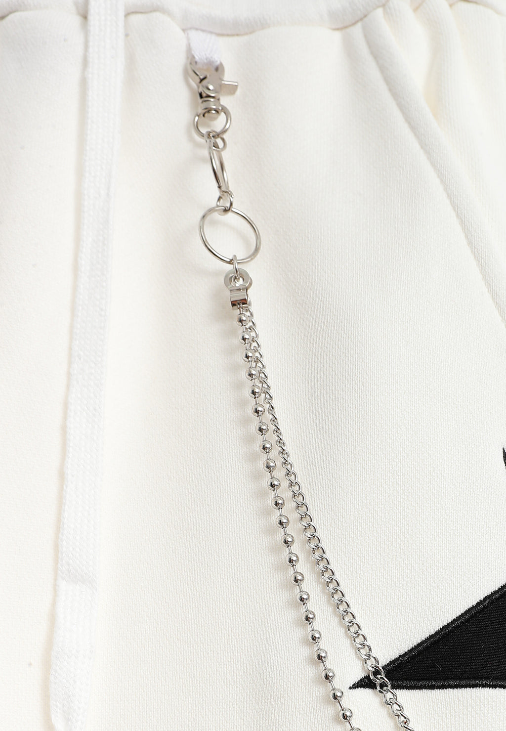 Pantalón jogger Wings con parches de estrellas y cadena lateral | MWM [PS_COLORS:WHITE]
